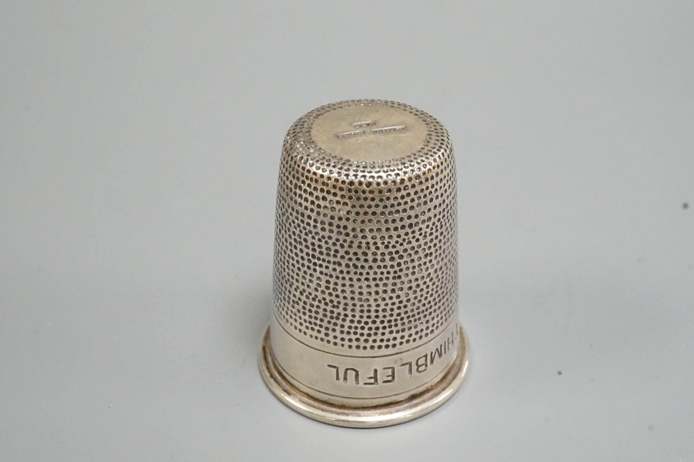 A sterling 'Just a Thimbleful' tot, stamped K.P.D, 51mm.